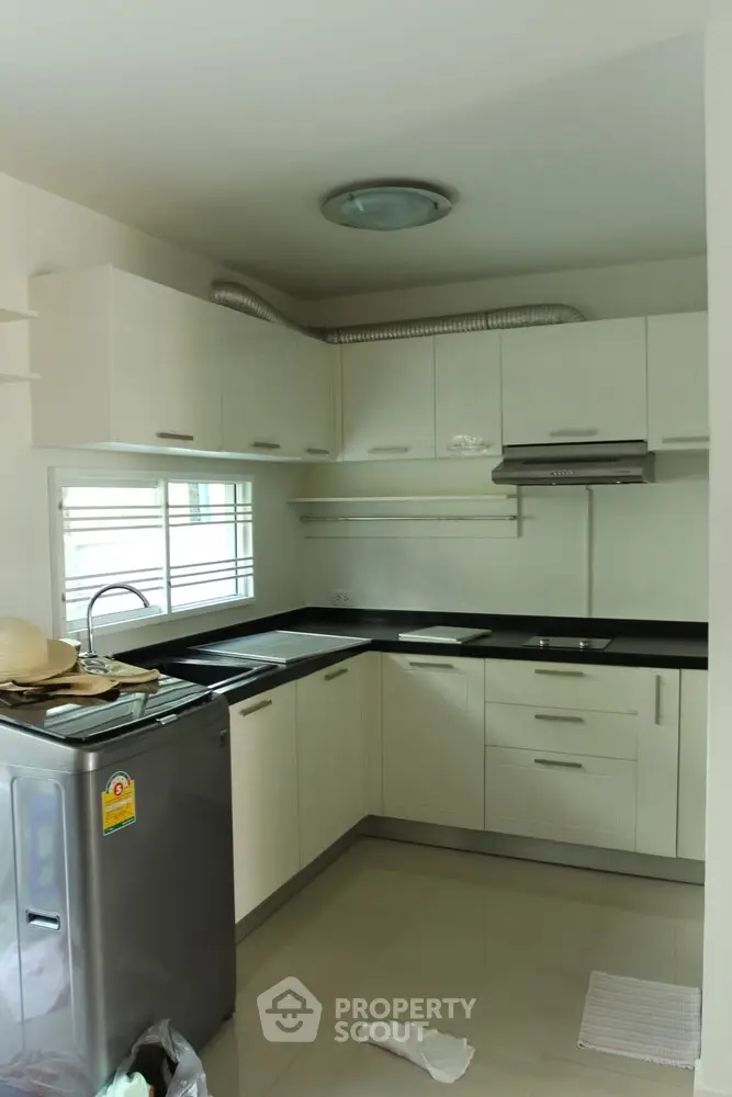 Modern kitchen with sleek cabinets and stainless steel appliances in a compact layout.