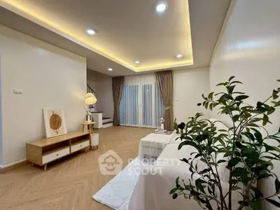 Spacious modern living room with elegant lighting and cozy decor