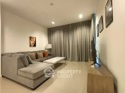 Spacious living room with modern decor and cozy sectional sofa.
