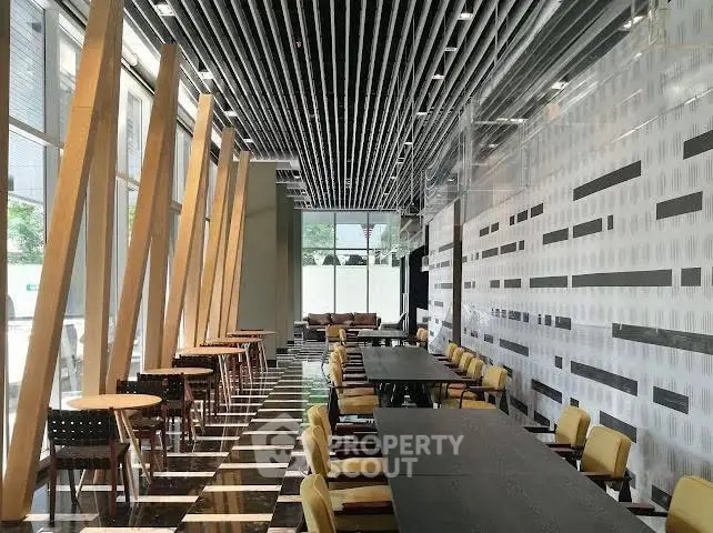 Modern co-working space with stylish decor and ample seating in a contemporary building.