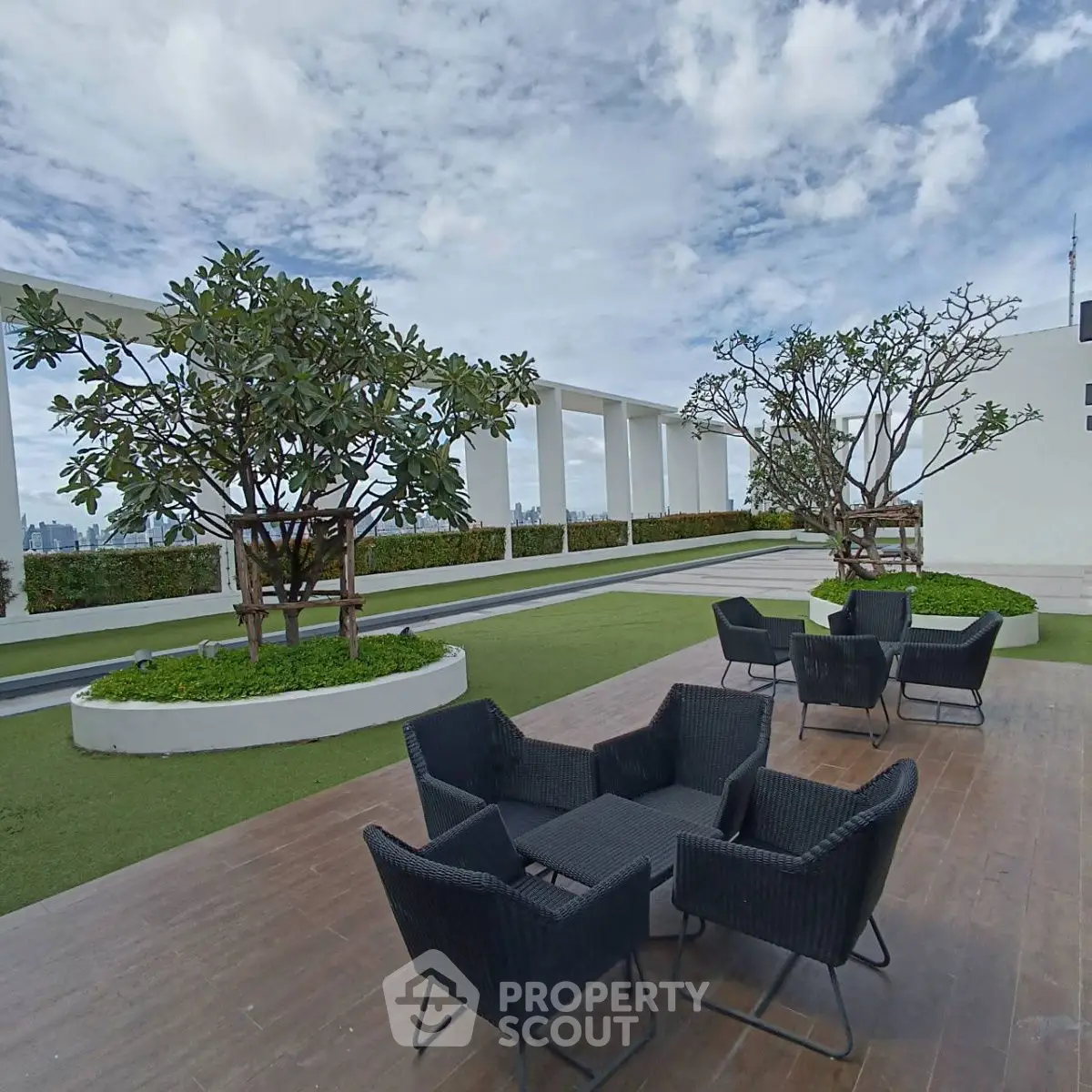 Stunning rooftop terrace with modern seating and lush greenery, perfect for relaxation and city views.