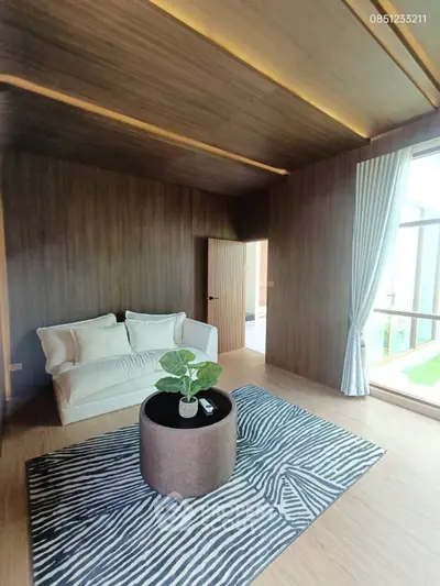 Spacious modern living room with wooden accents and large windows
