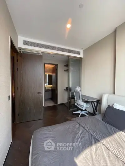 Modern bedroom with study area and ensuite bathroom in luxury apartment