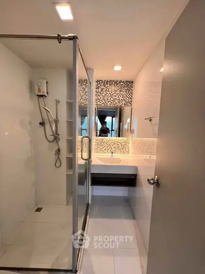Modern bathroom with glass shower and stylish tile accents