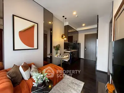 Modern living room with stylish decor and compact kitchen in open layout apartment.