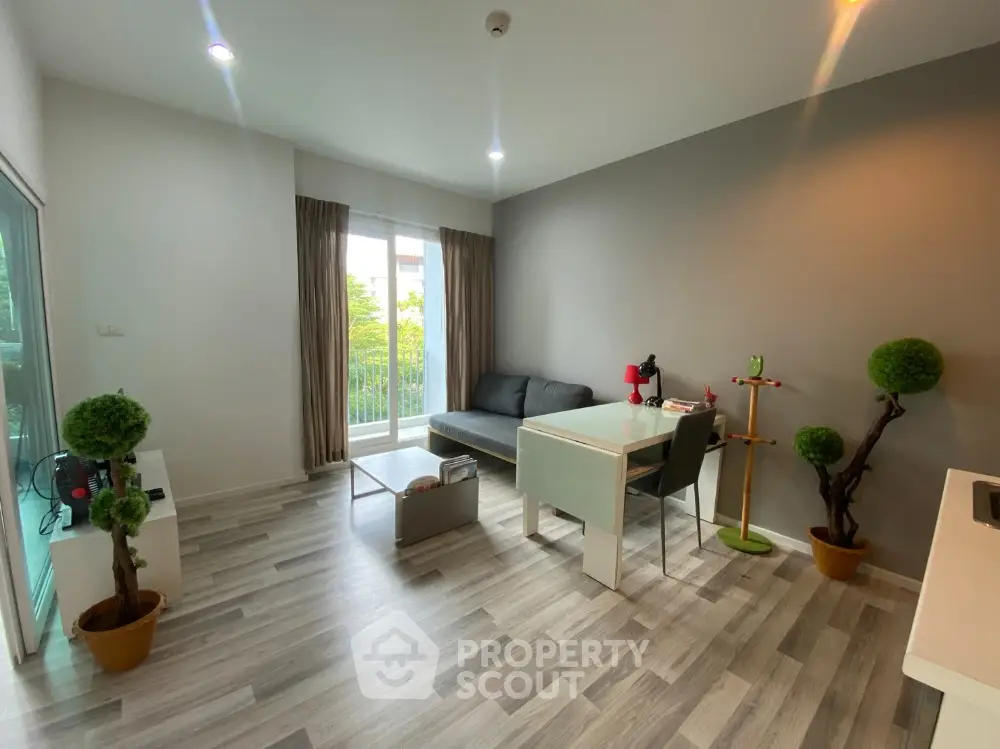 Modern living room with stylish decor and balcony view