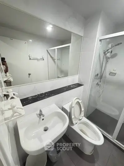 Modern bathroom with sleek fixtures and glass shower enclosure