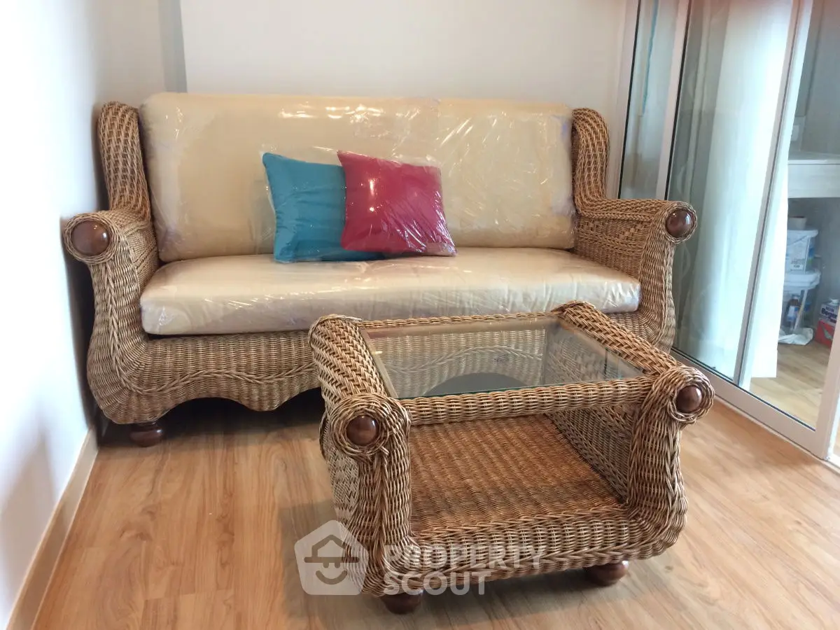 Charming wicker furniture set in cozy living room with wooden flooring.
