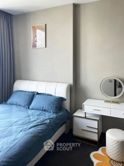 Modern bedroom with stylish decor and elegant furniture, featuring a cozy bed and chic vanity set.