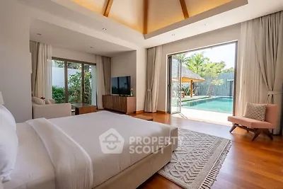 Luxurious bedroom with pool view and elegant decor in modern villa