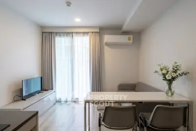Modern living room with sleek furniture and natural light, featuring a cozy sofa and elegant decor.