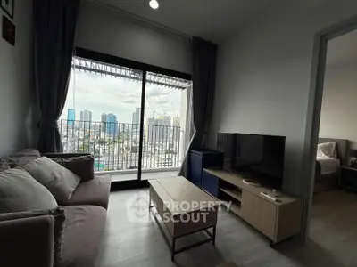Modern living room with city view, cozy sofa, and sleek entertainment unit in high-rise apartment.