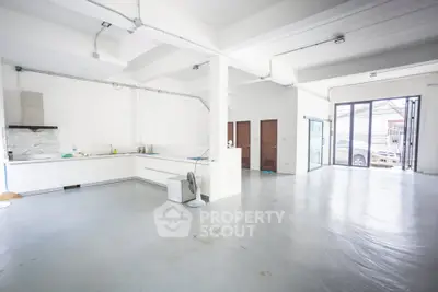 Spacious open-plan kitchen and living area with modern design and ample natural light.