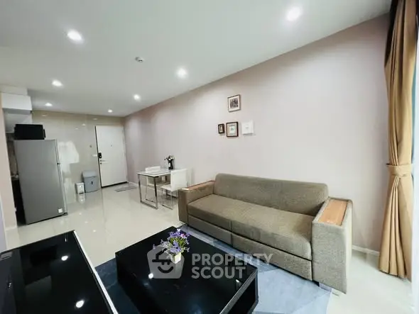 Modern living room with sleek furniture and natural light, perfect for relaxation and entertaining.