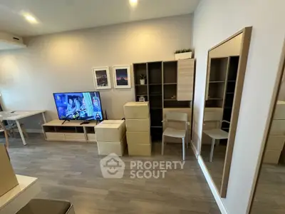 Modern living room with stylish furniture and wall-mounted TV, perfect for relaxation and entertainment.