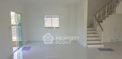 Spacious modern living room with staircase and large windows