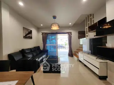 Modern living room with sleek black sofa and stylish lighting