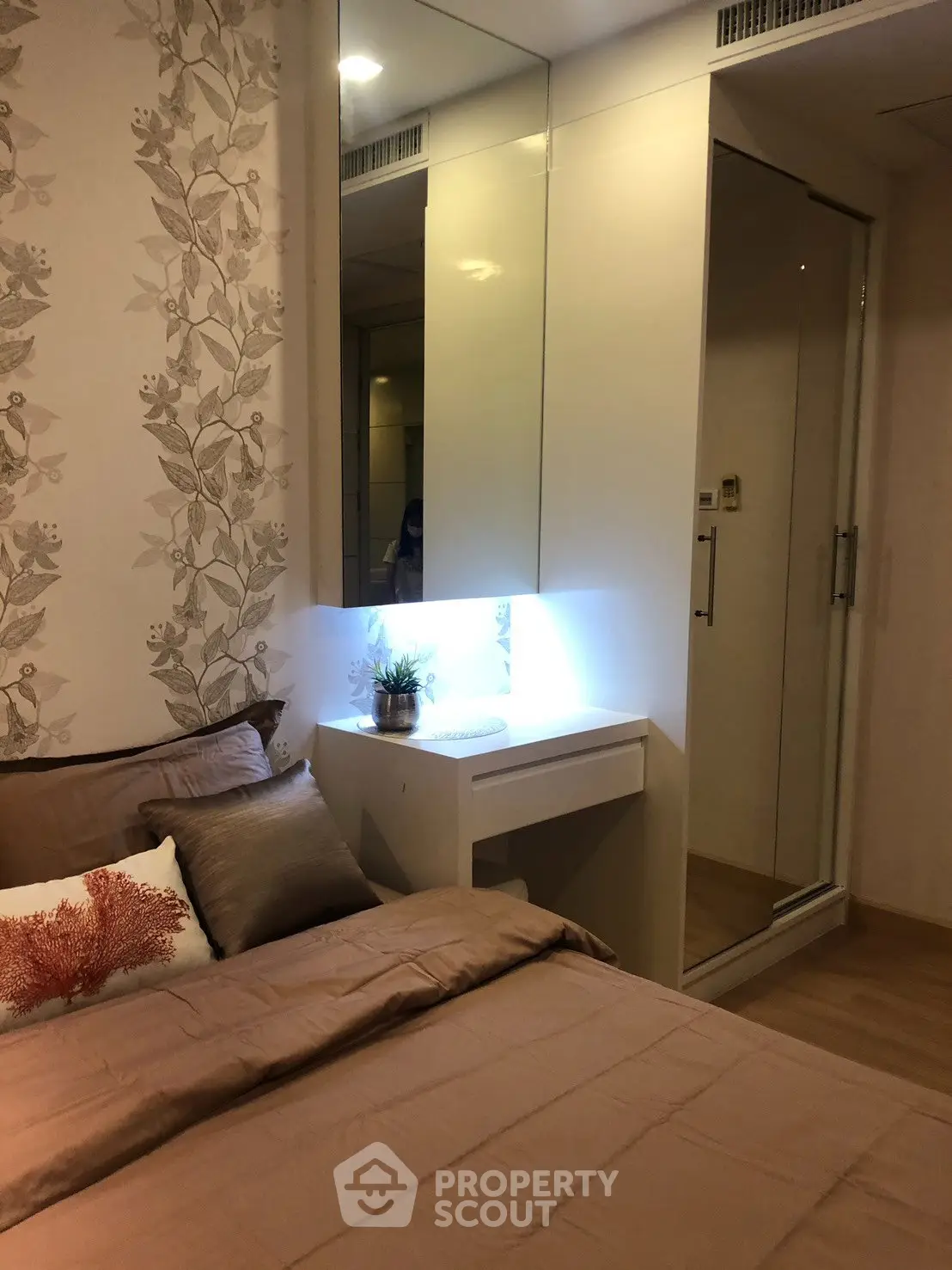 Cozy bedroom with elegant decor and mirrored wardrobe