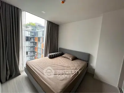 Modern bedroom with large window and urban view in contemporary apartment