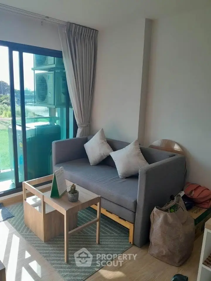 Cozy living room with modern sofa and natural light from large window