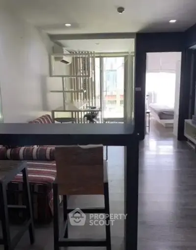 Modern open-plan living area with stylish decor and natural light