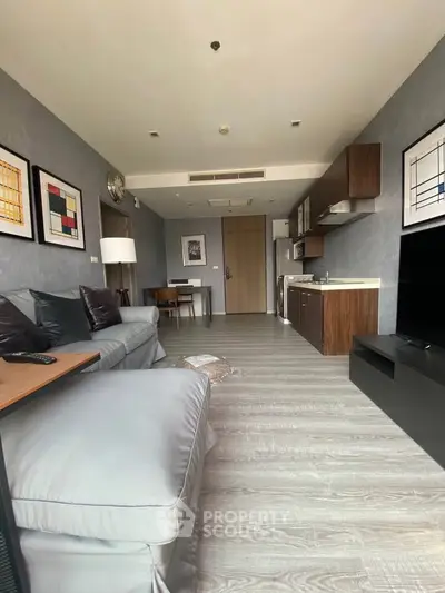 Modern living room with sleek furniture and open kitchen layout, perfect for urban living.