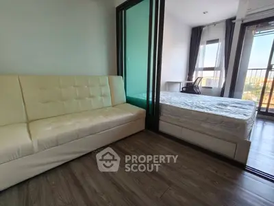 Modern apartment with cozy living room and bedroom, featuring large windows and stylish flooring.
