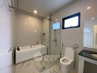 Luxurious modern bathroom with glass shower and sleek fixtures