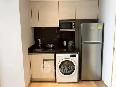 Modern compact kitchen with sleek appliances and wooden cabinetry