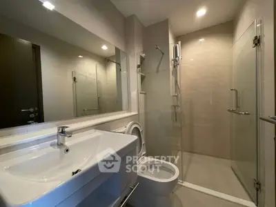 Modern bathroom with sleek fixtures and glass shower enclosure