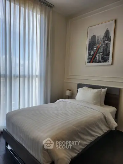 Cozy bedroom with modern decor and large window for natural light