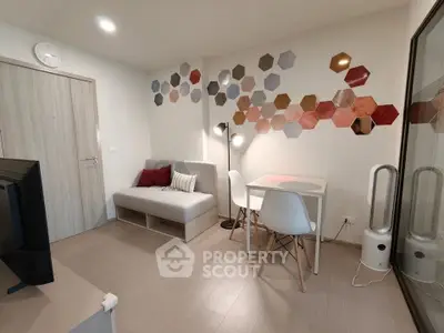 Modern living room with stylish hexagonal wall decor and cozy seating area.