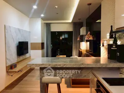 Luxurious modern kitchen with marble countertops and open layout in a stylish apartment.