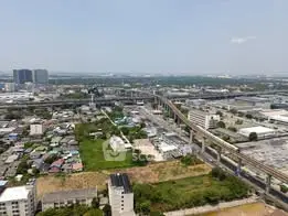 Aerial view of urban landscape with residential and commercial buildings, showcasing city infrastructure and skyline.