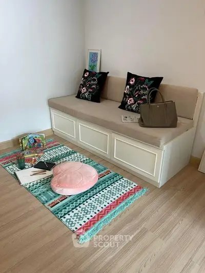 Cozy living room corner with stylish sofa and colorful decor accents.