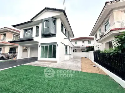 Modern two-story house with spacious driveway and lush green lawn