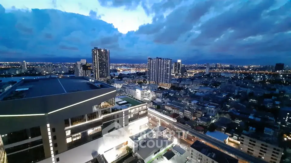 Stunning cityscape view from high-rise building at dusk, showcasing urban skyline and vibrant city lights.
