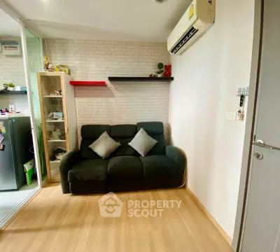 Cozy living room with modern decor and air conditioning in a stylish apartment.