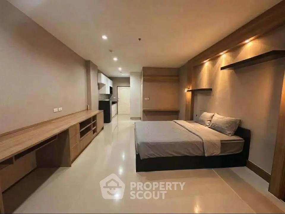 Spacious modern bedroom with sleek design and ample storage in a contemporary apartment.
