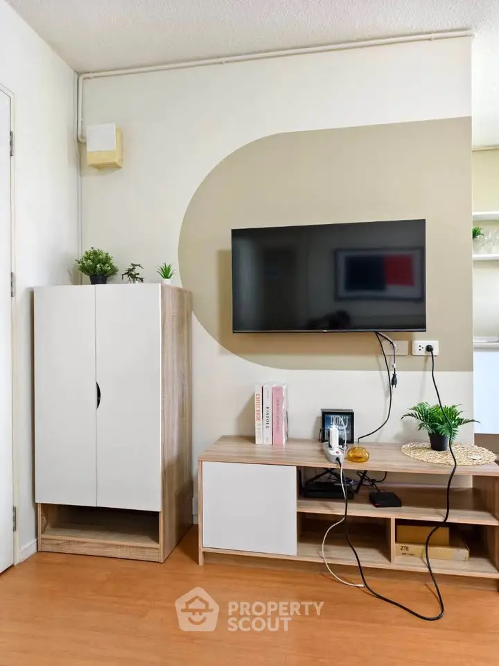 Modern living room with wall-mounted TV and stylish storage units