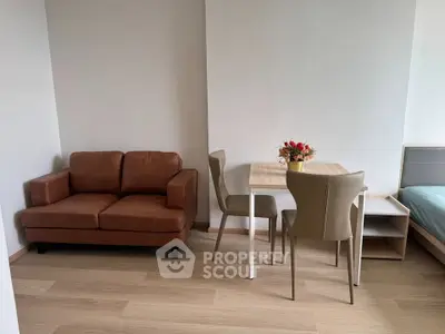 Modern living room with cozy brown sofa and elegant dining set in a bright apartment.