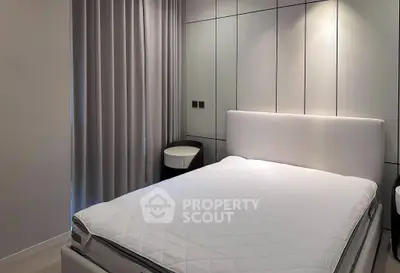 Modern bedroom with sleek design and ambient lighting, featuring a comfortable bed and stylish side tables.