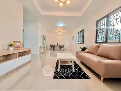 Spacious modern living room with elegant decor and ample natural light.