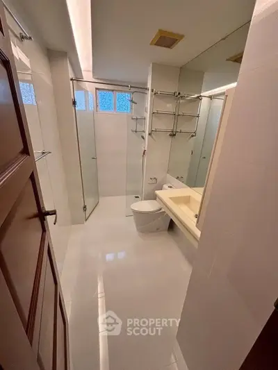 Modern bathroom with glass shower and sleek fixtures