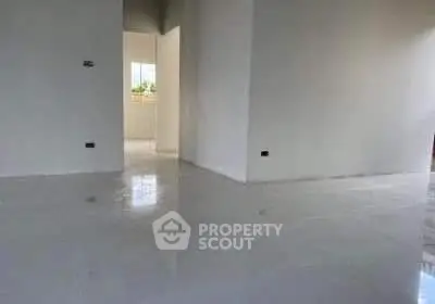 Spacious empty room with glossy white floors and high ceiling