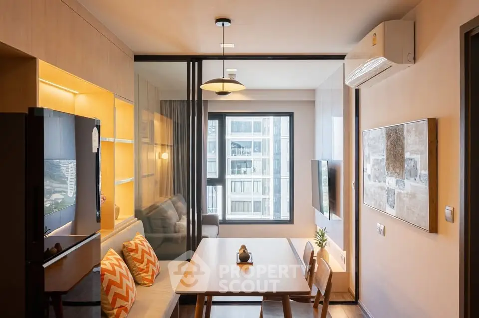 Modern apartment interior with dining area and cozy living space, featuring large window and stylish decor.
