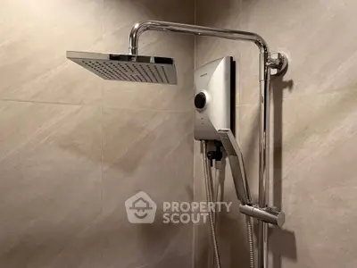Modern bathroom with sleek shower system and elegant tile design.