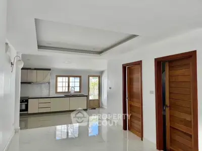 Spacious modern kitchen with sleek cabinetry and open layout, perfect for culinary enthusiasts.