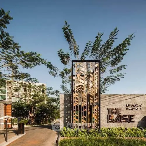Modern entrance of The Base Uptown Phuket with lush greenery and contemporary design.