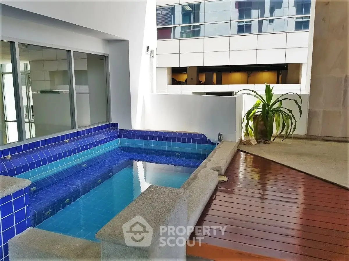 Luxurious indoor pool area with modern design and elegant wooden flooring.